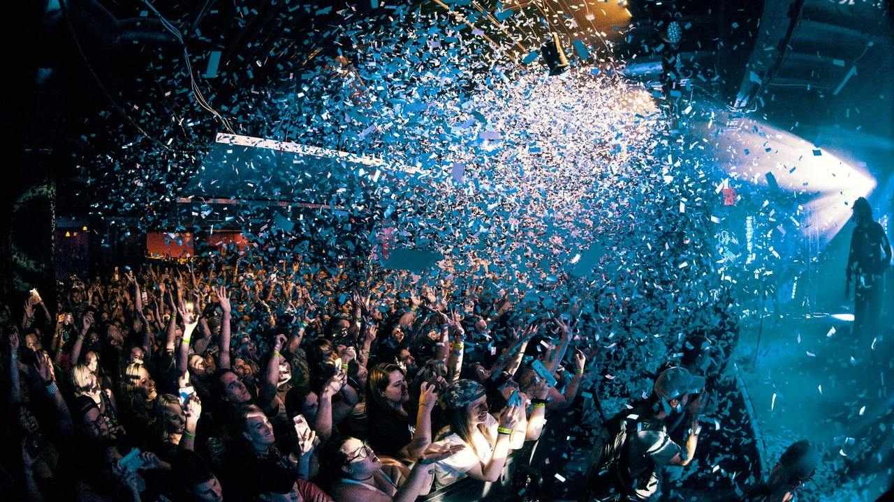 People partying in a nightclub with confetti in the air